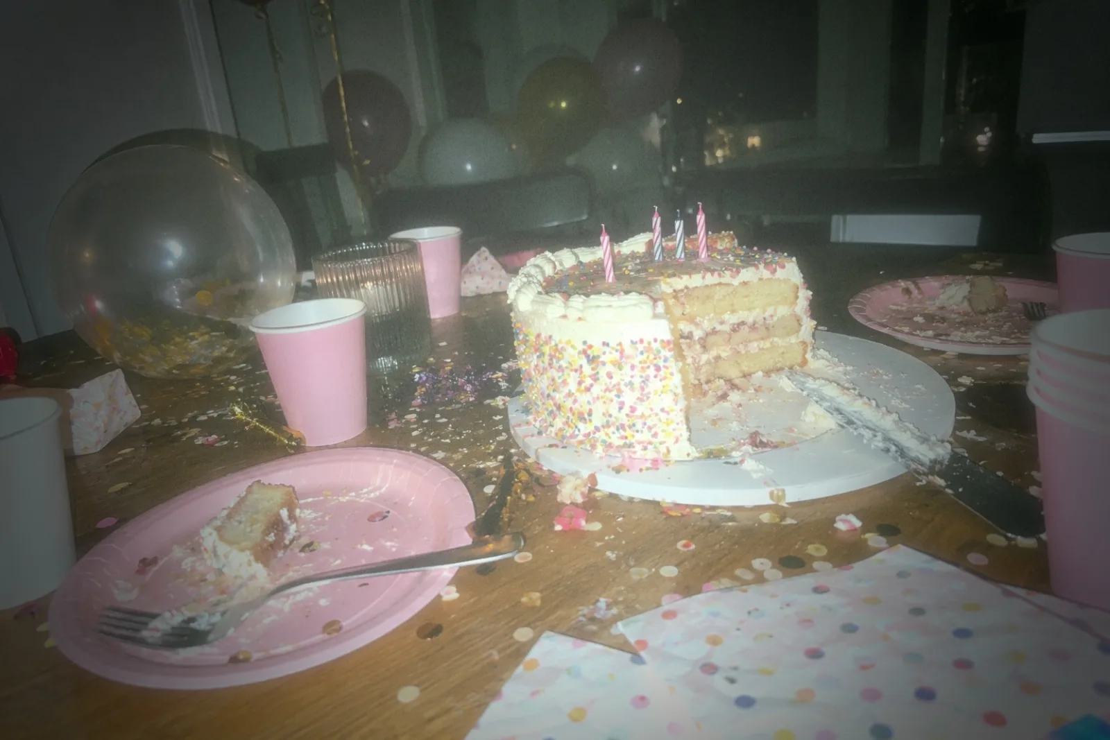 A half-eaten birthday cake on a party table, shot on the POCKET 98
